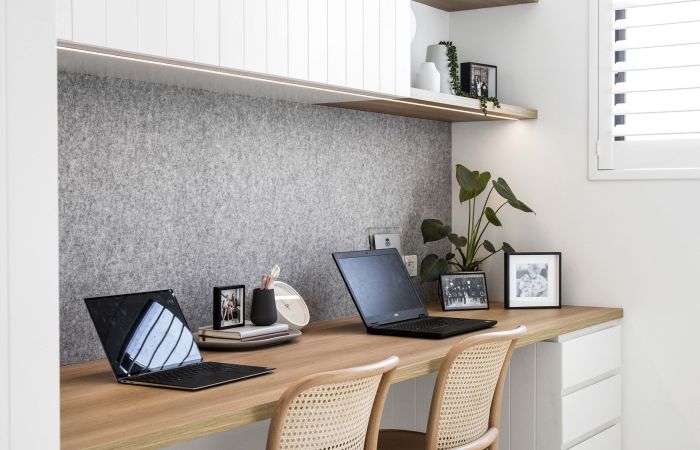 two computers open at ahome office desk